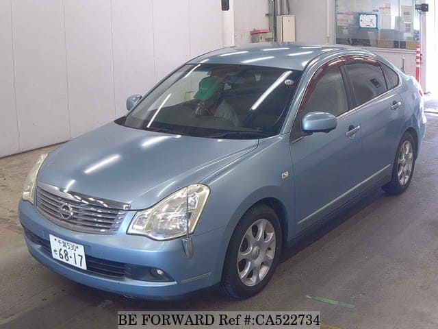 A grey JDM sports car speeding down a highway at night.