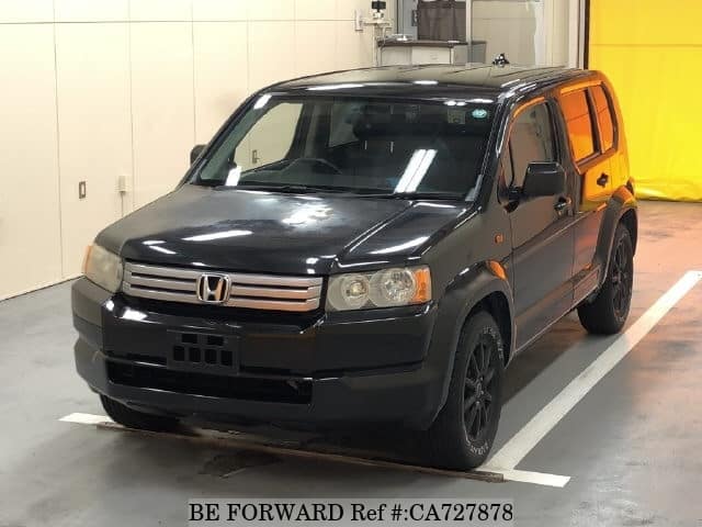 A grey JDM sports car speeding down a highway at night.