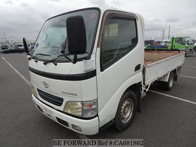 A grey JDM sports car speeding down a highway at night.