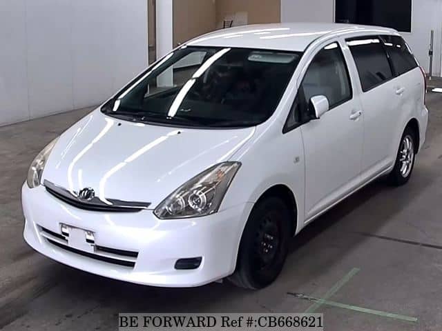 A grey JDM sports car speeding down a highway at night.