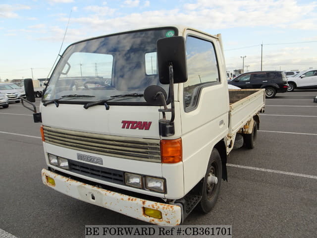 A grey JDM sports car speeding down a highway at night.