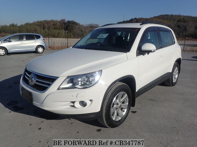 A grey JDM sports car speeding down a highway at night.