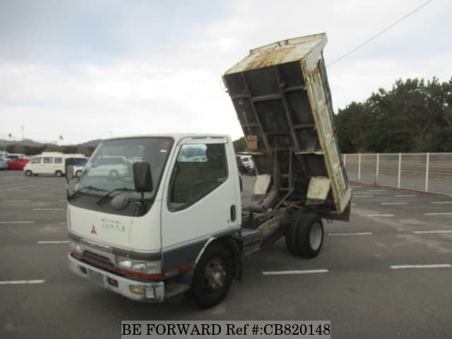 A grey JDM sports car speeding down a highway at night.