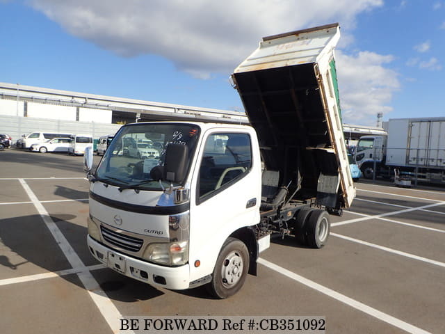 A grey JDM sports car speeding down a highway at night.