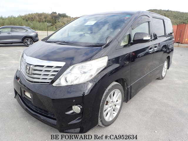 A grey JDM sports car speeding down a highway at night.