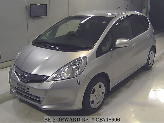 A grey JDM sports car speeding down a highway at night.