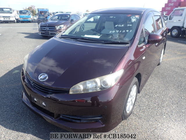 A grey JDM sports car speeding down a highway at night.