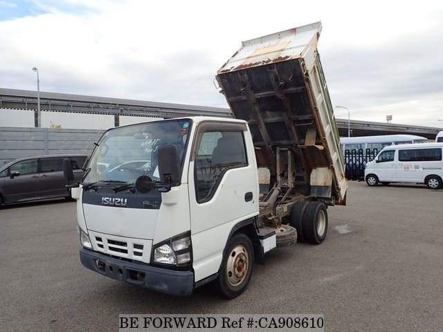 A grey JDM sports car speeding down a highway at night.