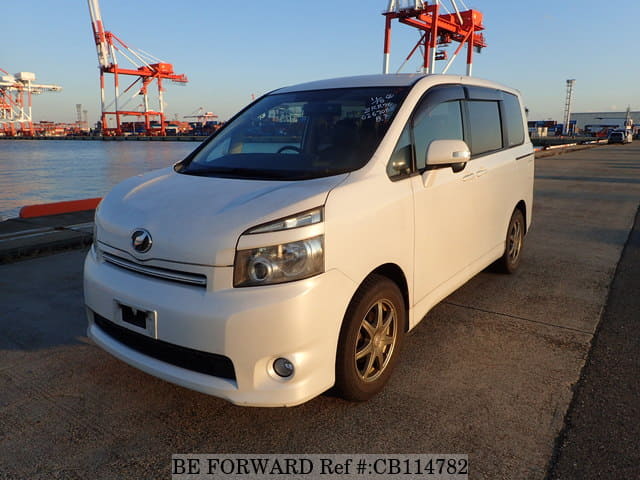 A grey JDM sports car speeding down a highway at night.