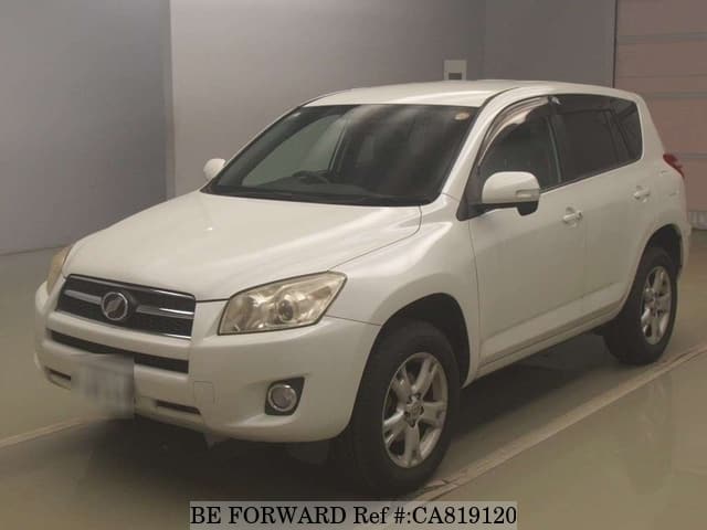 A grey JDM sports car speeding down a highway at night.