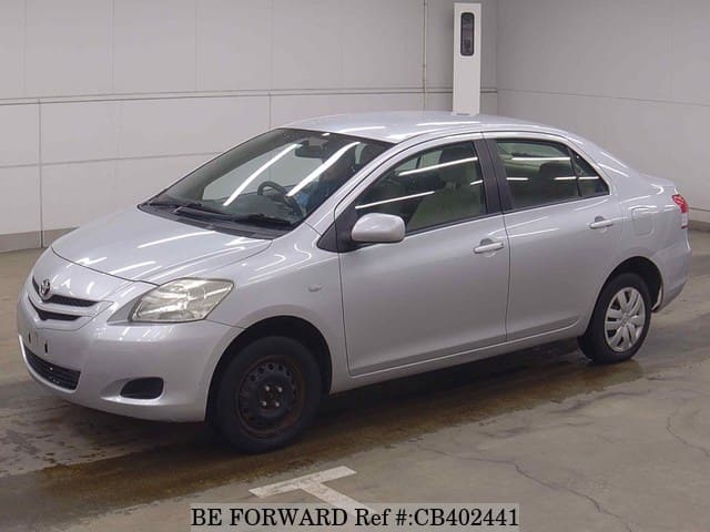 A grey JDM sports car speeding down a highway at night.