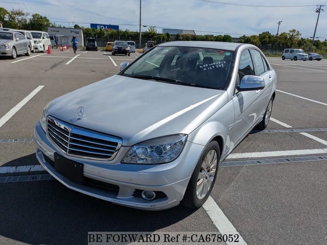 A grey JDM sports car speeding down a highway at night.