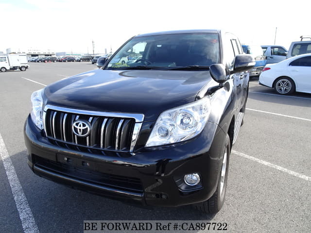 A grey JDM sports car speeding down a highway at night.