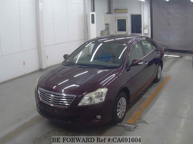 A grey JDM sports car speeding down a highway at night.