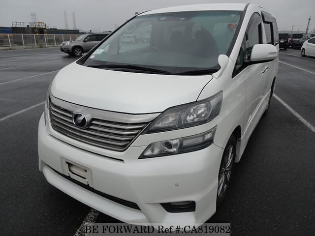 A grey JDM sports car speeding down a highway at night.