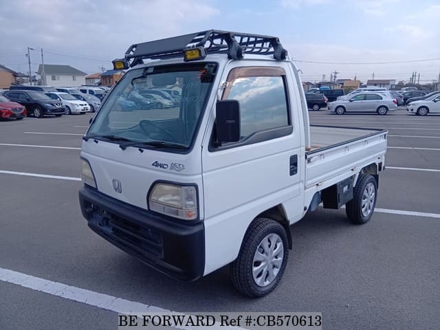 A grey JDM sports car speeding down a highway at night.