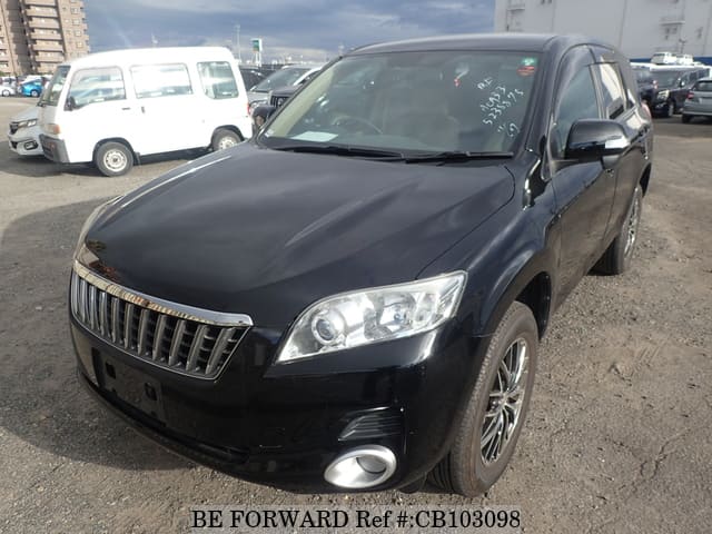 A grey JDM sports car speeding down a highway at night.