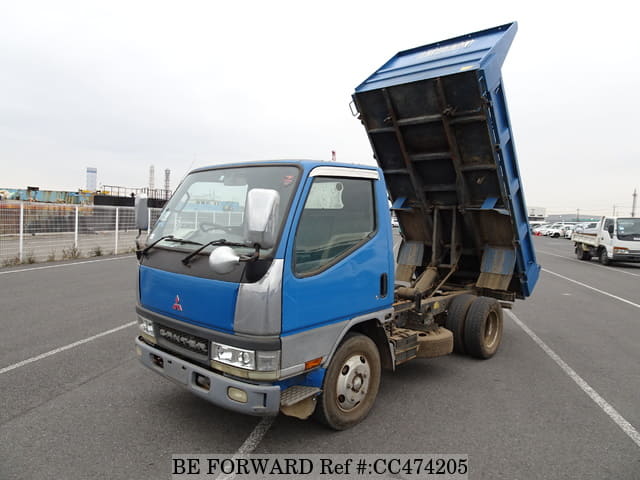 A grey JDM sports car speeding down a highway at night.