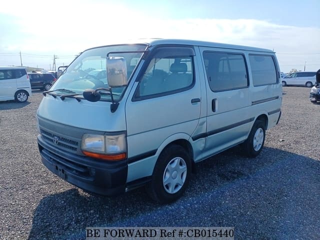 A grey JDM sports car speeding down a highway at night.