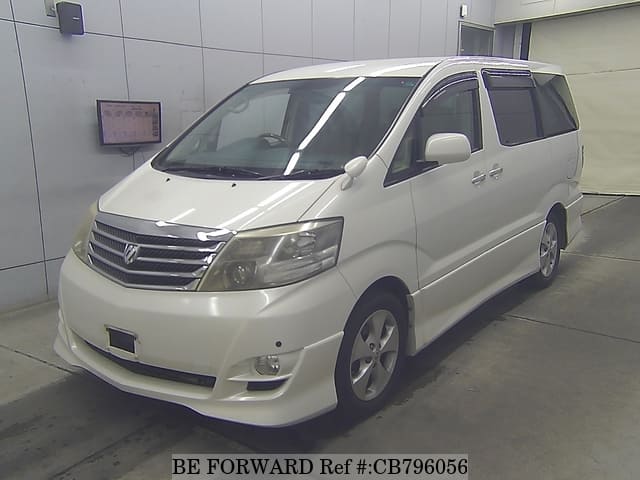 A grey JDM sports car speeding down a highway at night.
