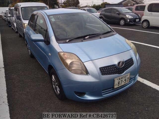 A grey JDM sports car speeding down a highway at night.
