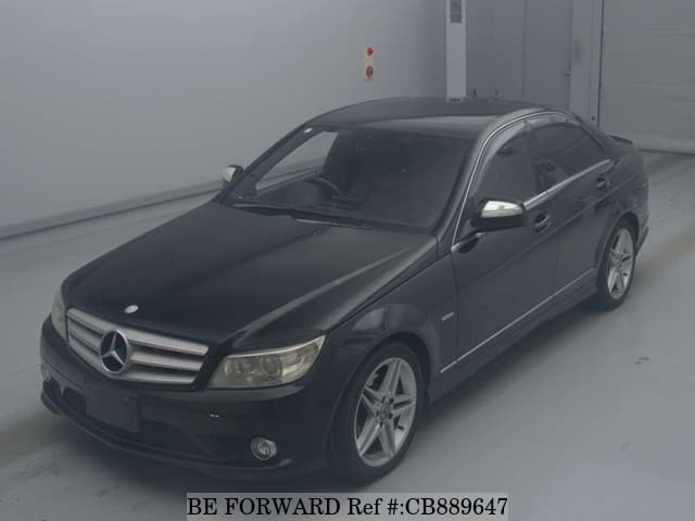 A grey JDM sports car speeding down a highway at night.