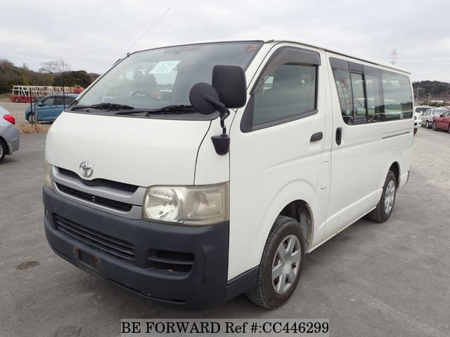 A grey sports car speeding down a highway at night.