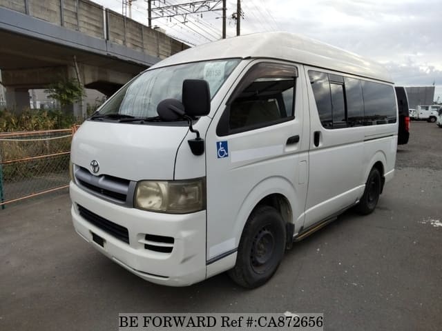 A grey JDM sports car speeding down a highway at night.
