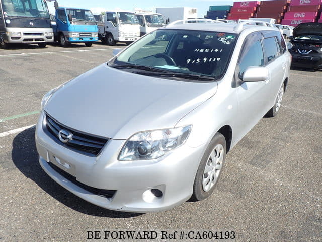 A grey JDM sports car speeding down a highway at night.