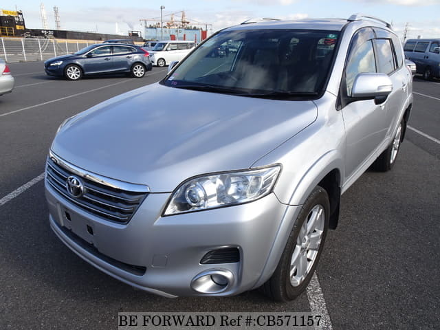 A grey JDM sports car speeding down a highway at night.