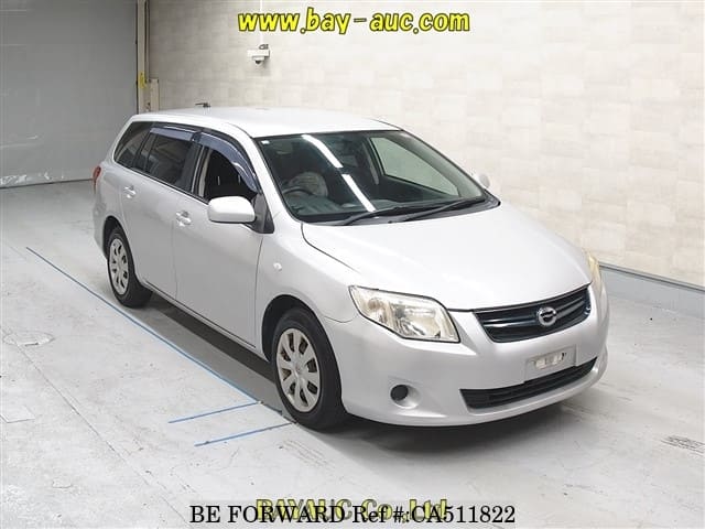 A grey JDM sports car speeding down a highway at night.