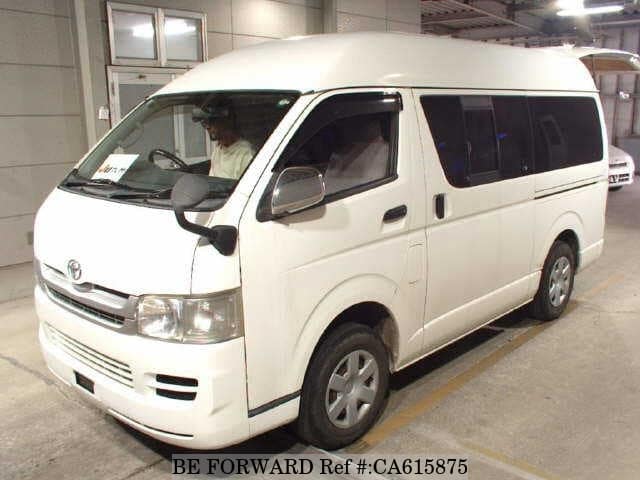 A grey JDM sports car speeding down a highway at night.