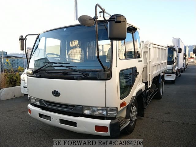 A grey JDM sports car speeding down a highway at night.
