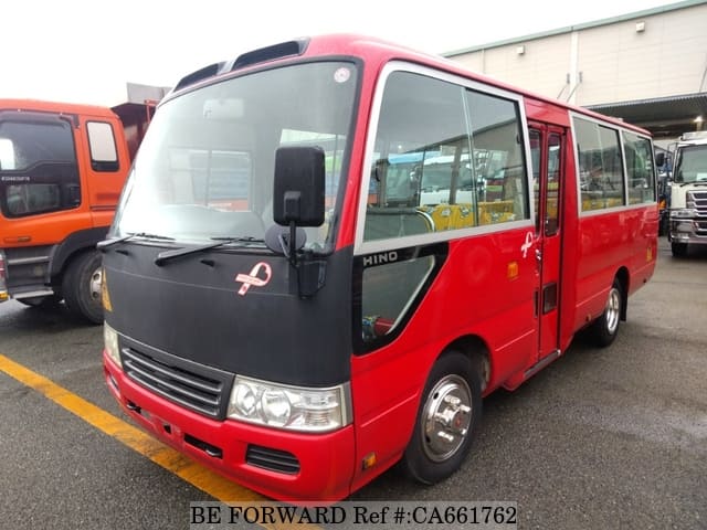 A grey JDM sports car speeding down a highway at night.