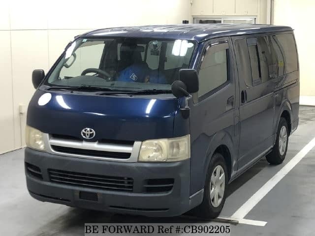 A grey JDM sports car speeding down a highway at night.