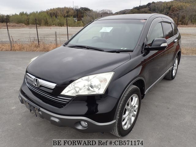 A grey JDM sports car speeding down a highway at night.