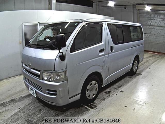 A grey JDM sports car speeding down a highway at night.