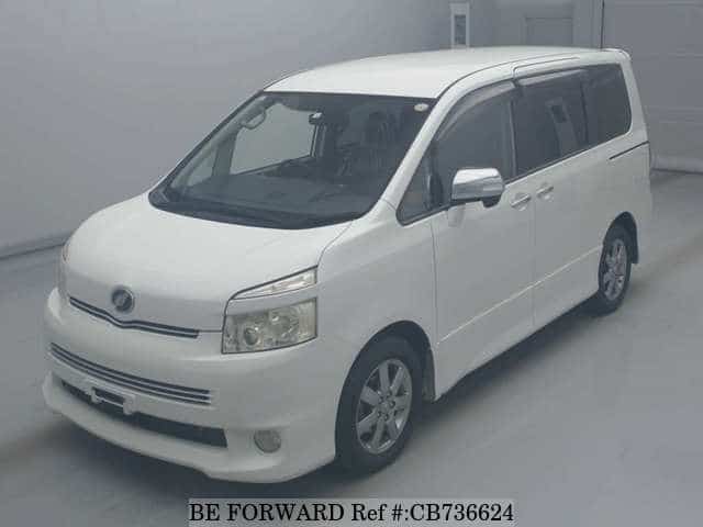 A grey JDM sports car speeding down a highway at night.