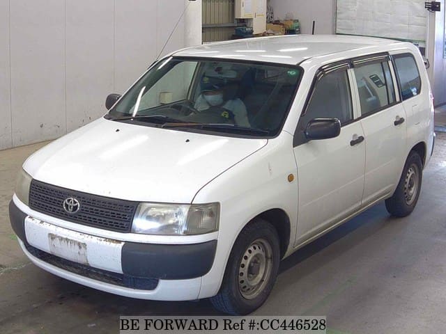 A grey JDM sports car speeding down a highway at night.
