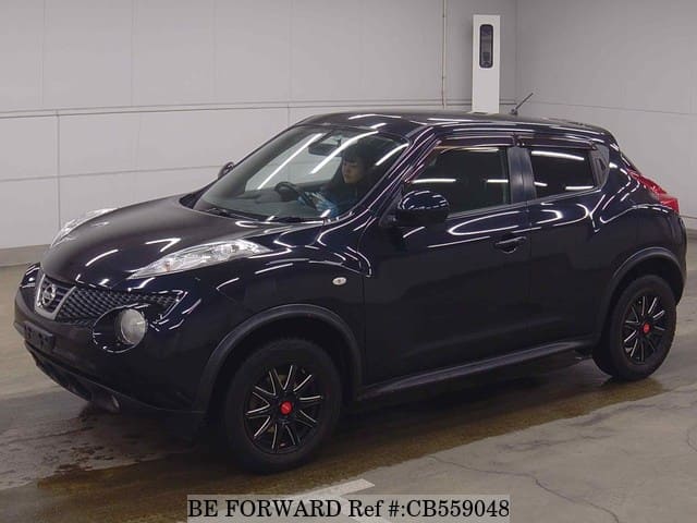 A grey JDM sports car speeding down a highway at night.