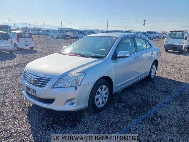 A grey JDM sports car speeding down a highway at night.