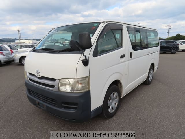 A grey JDM sports car speeding down a highway at night.
