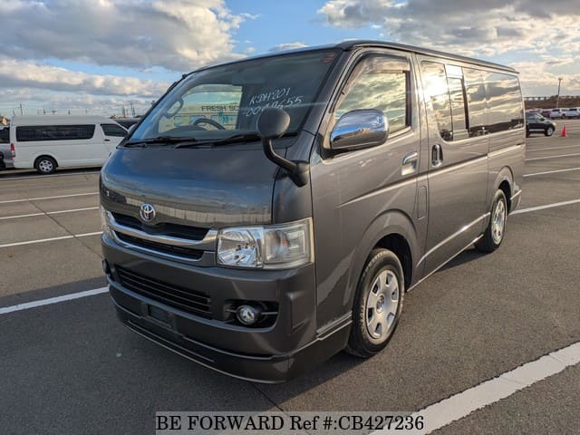 A grey JDM sports car speeding down a highway at night.