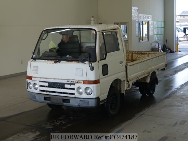A grey JDM sports car speeding down a highway at night.