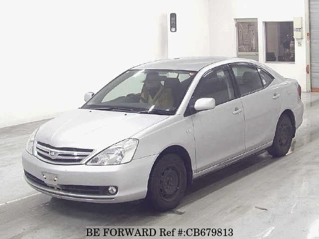 A grey JDM sports car speeding down a highway at night.