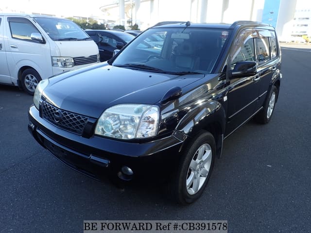 A grey JDM sports car speeding down a highway at night.