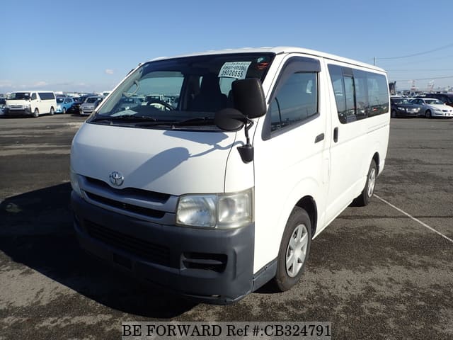 A grey JDM sports car speeding down a highway at night.