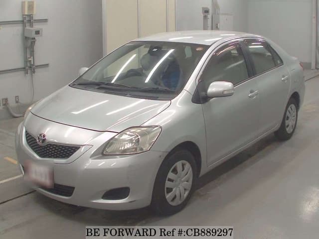 A grey JDM sports car speeding down a highway at night.