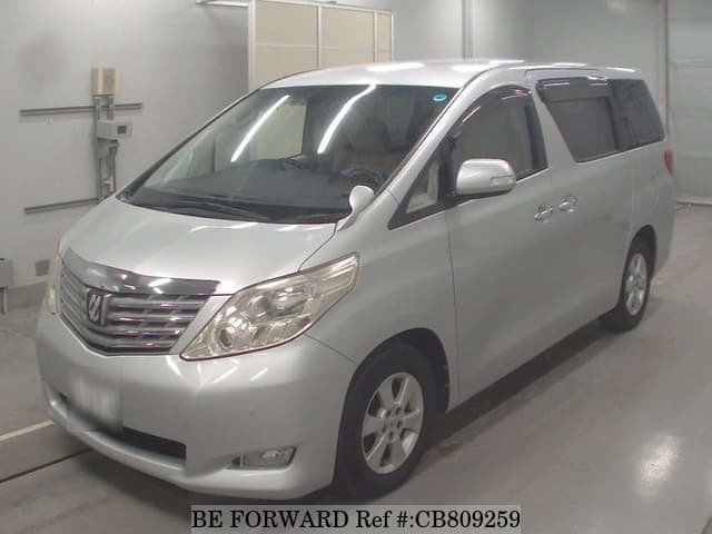 A grey JDM sports car speeding down a highway at night.