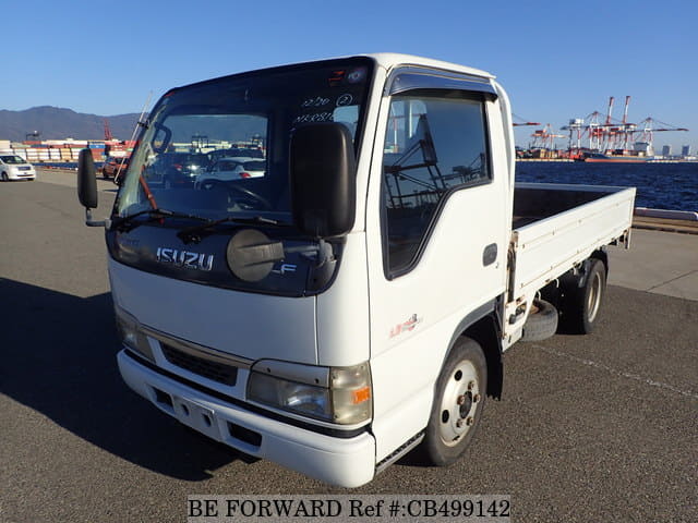 A grey JDM sports car speeding down a highway at night.